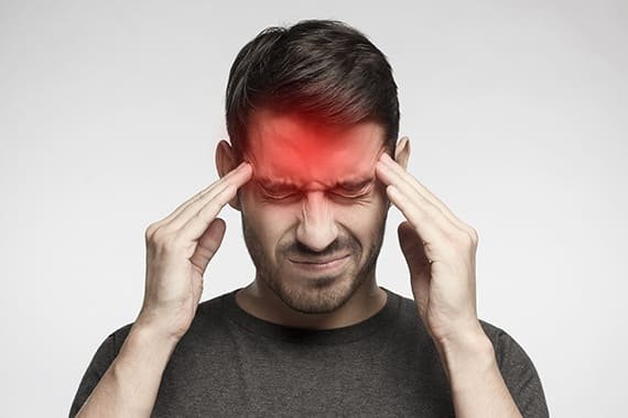 man holding head headache